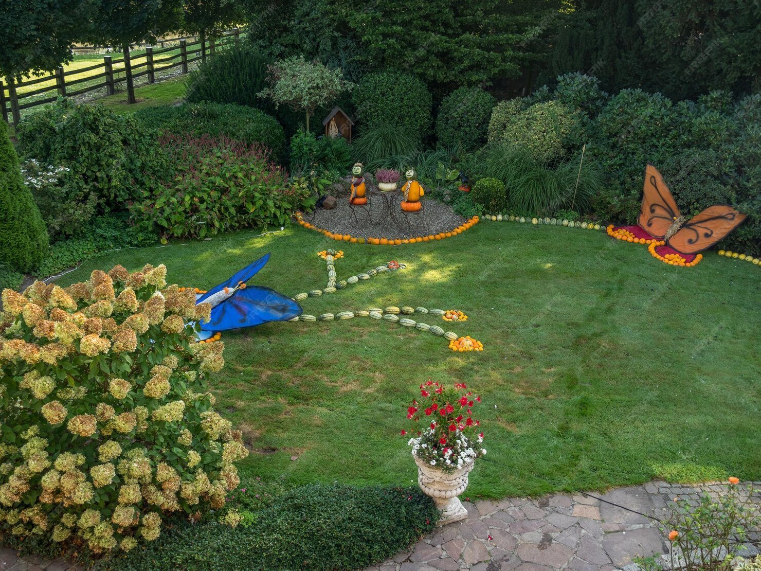 A lush, perfectly manicured estate garden with sharp hedge lines and vibrant green grass during soft afternoon golden hour